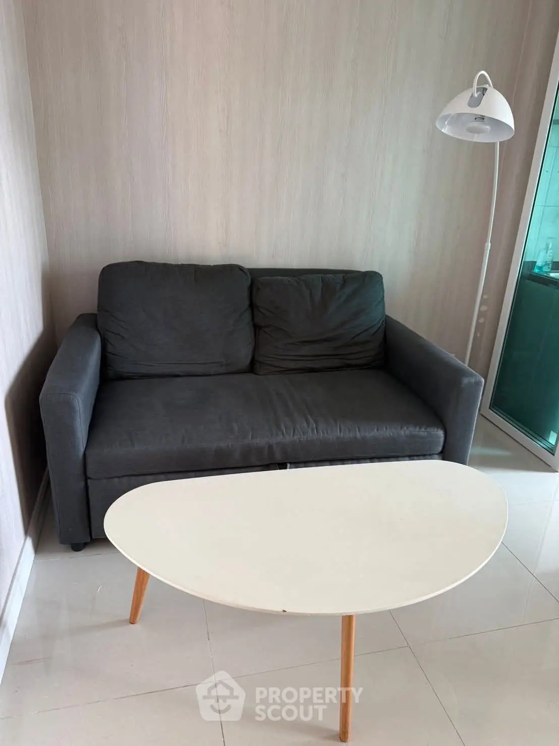 Cozy living room with modern sofa and stylish coffee table, perfect for relaxation.