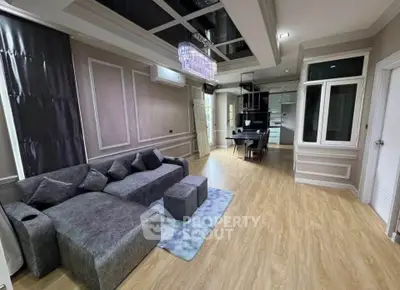 Luxurious modern living room with elegant decor and spacious layout, featuring a stylish sofa and chic lighting.