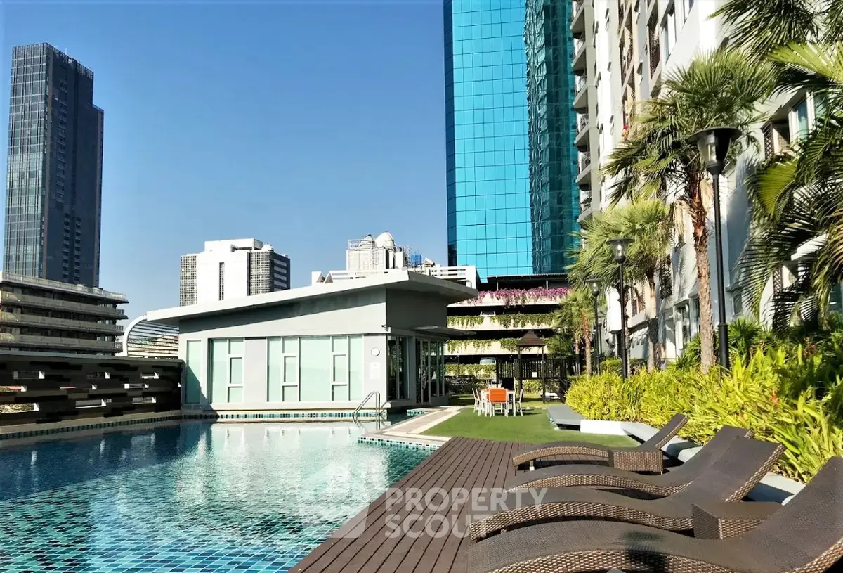 Luxurious urban apartment complex with rooftop pool and stunning city views.