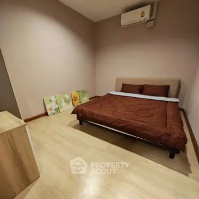 Cozy bedroom with modern decor and air conditioning in a stylish apartment.