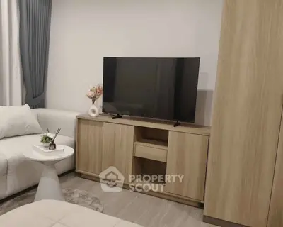 Modern living room with sleek TV stand and cozy sofa, perfect for relaxation and entertainment.