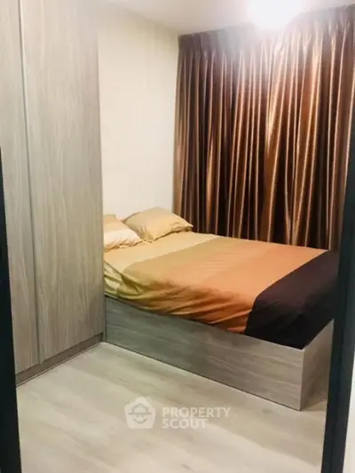 Cozy bedroom with modern wooden wardrobe and elegant curtains