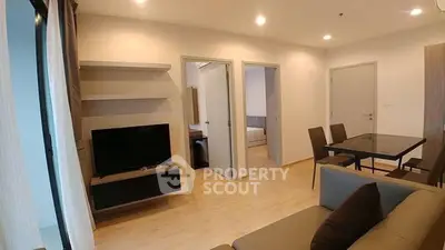 Modern living room with open layout, stylish furniture, and dining area in a cozy apartment.