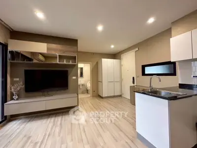 Modern open-plan living room with sleek kitchen and stylish decor