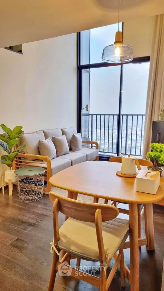 Modern living room with cozy seating and city view balcony
