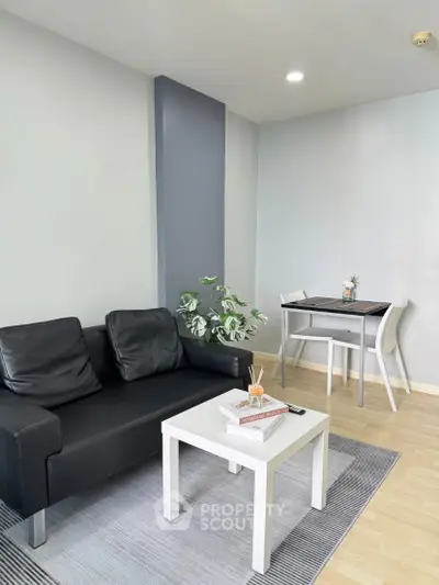 Modern living room with sleek black sofa and minimalist decor