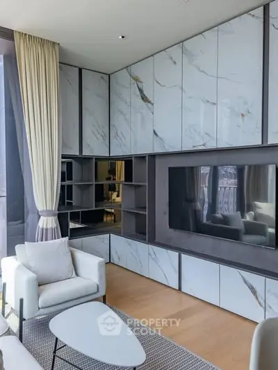 Luxurious modern living room with marble accents and large TV