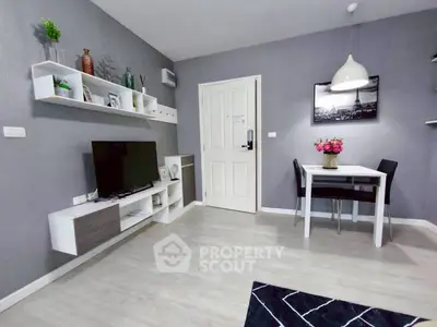 Modern living room with stylish decor and dining area in a cozy apartment.