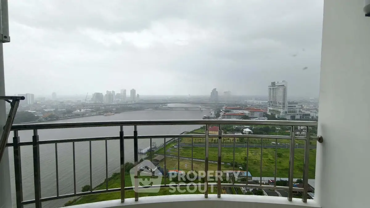 Stunning high-rise balcony view overlooking river and cityscape, perfect for urban living enthusiasts.
