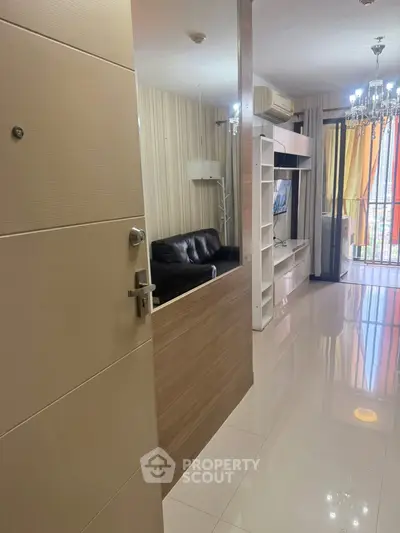 Modern living room with sleek design and balcony view, featuring elegant lighting and contemporary furniture.