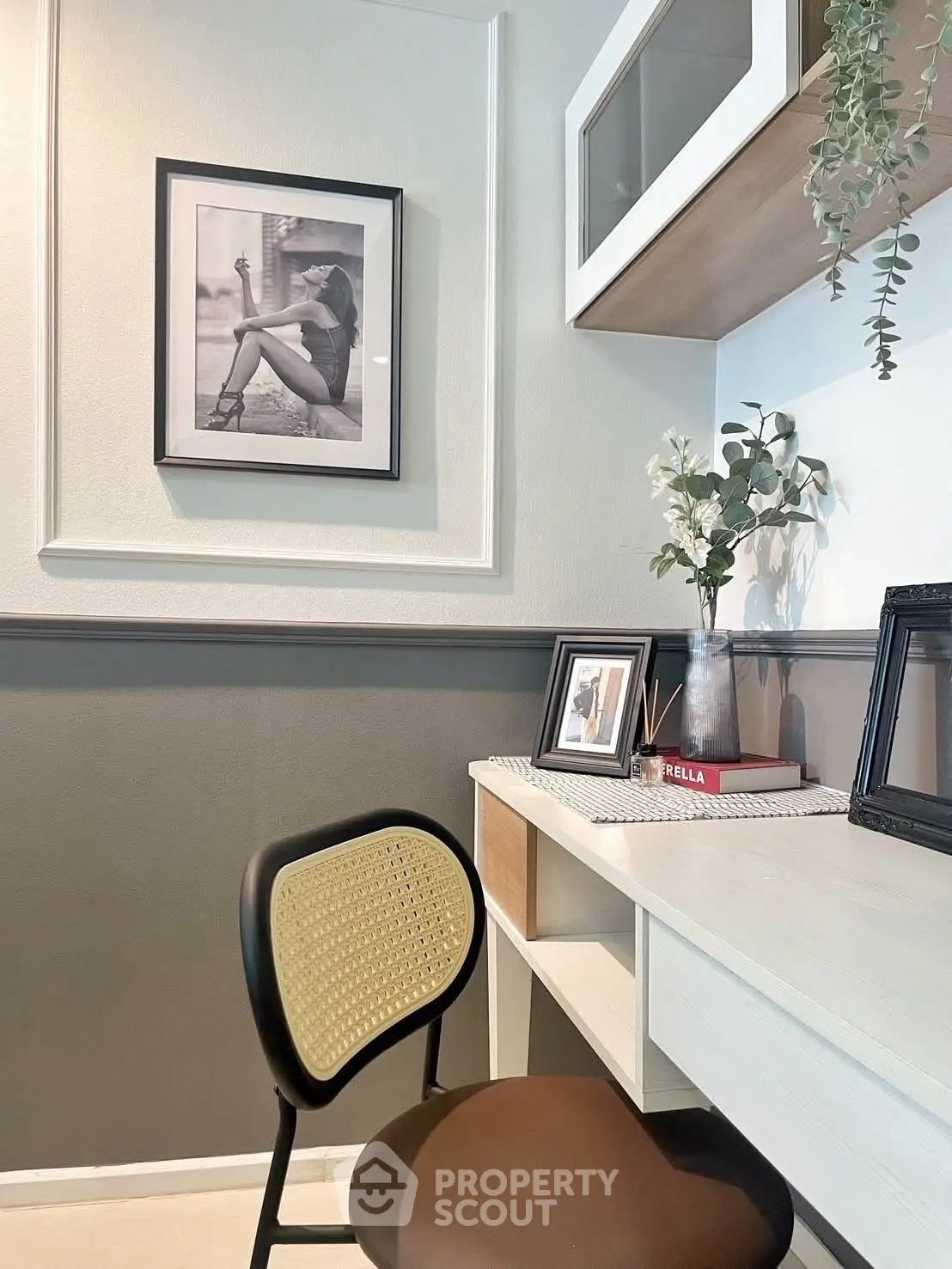 Chic study area with stylish chair, framed art, and modern shelving in a contemporary home.