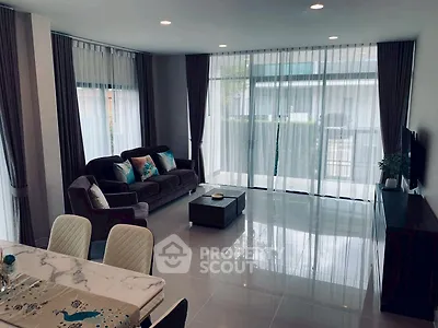 Spacious modern living room with elegant decor and large windows for natural light.