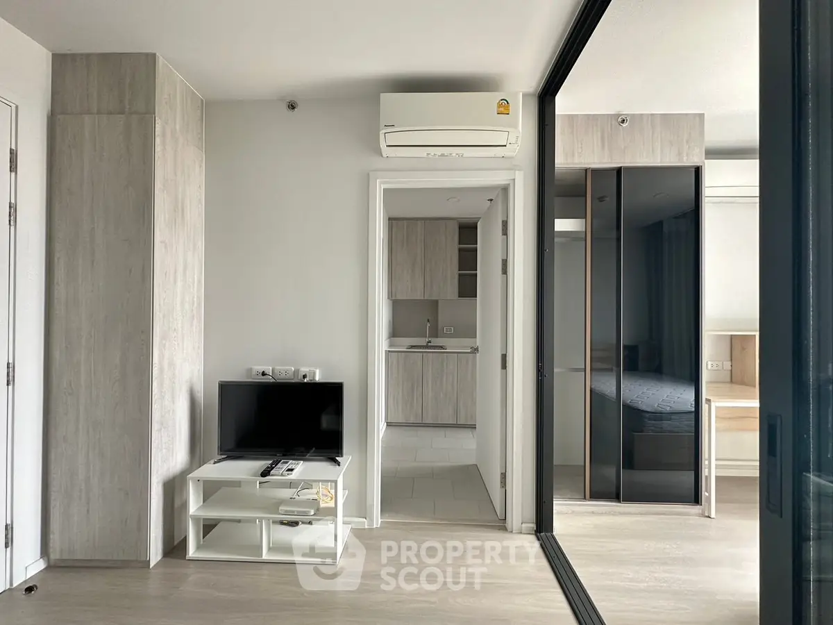 Modern apartment interior with sleek design, featuring a cozy living area and stylish bedroom.