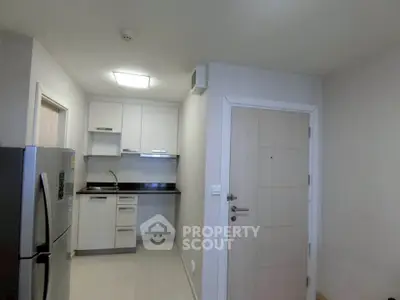 Modern compact kitchen with sleek appliances and minimalist design