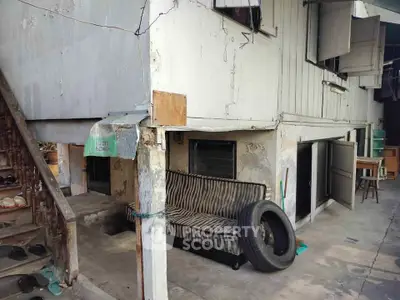 Rustic exterior of a vintage building with unique architectural features and outdoor seating area.