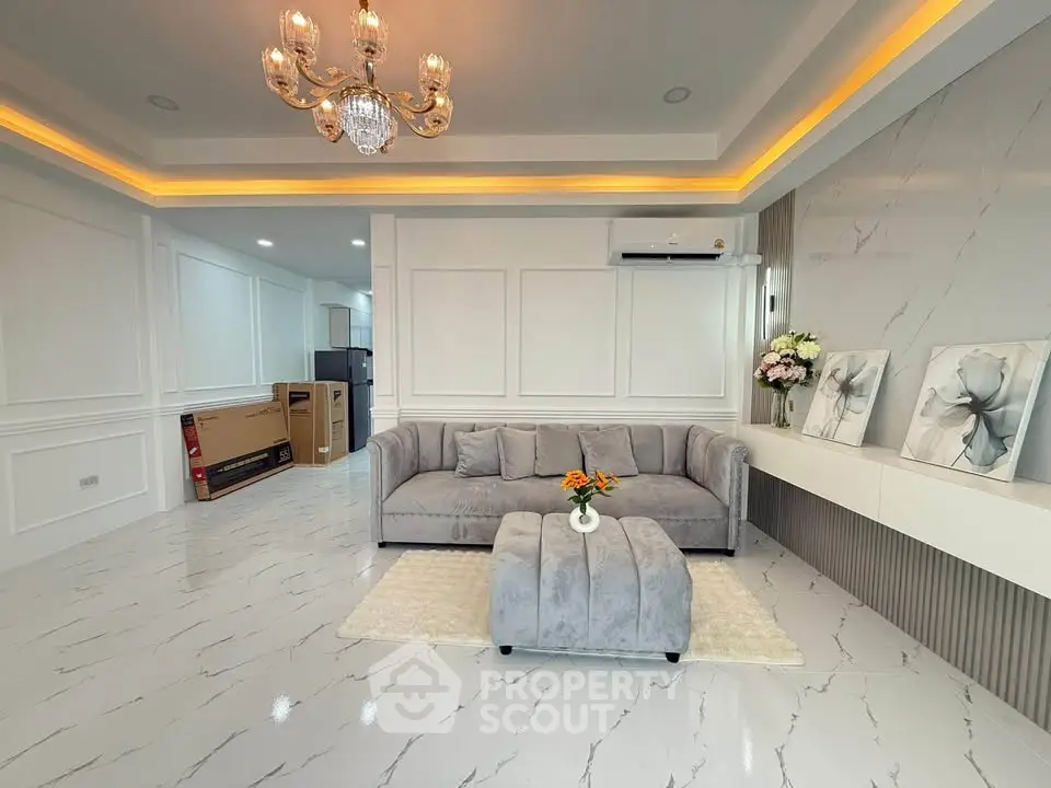 Elegant living room with chandelier, modern sofa, and stylish decor