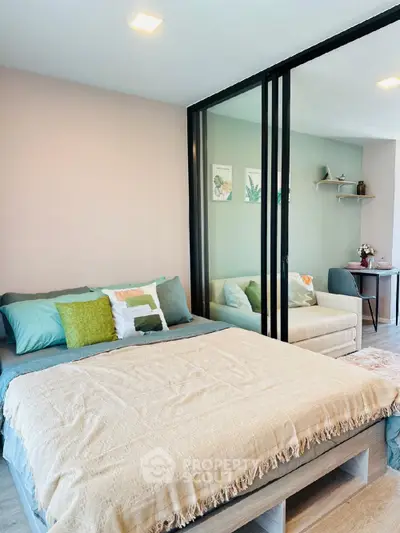 Modern bedroom with cozy decor and sliding glass partition in stylish apartment