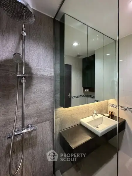 Modern bathroom with glass shower and sleek sink design