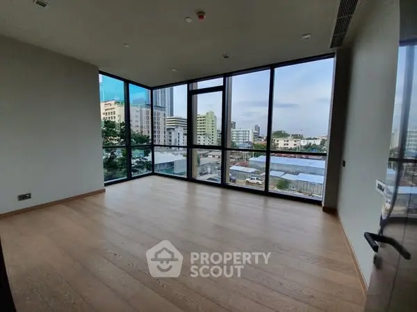 Spacious corner unit with floor-to-ceiling windows offering city views and natural light.