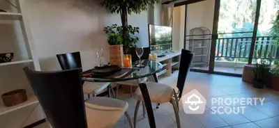 Charming living room with glass dining table and balcony view