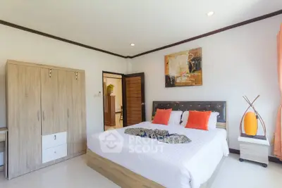 Spacious bedroom with modern decor and natural light