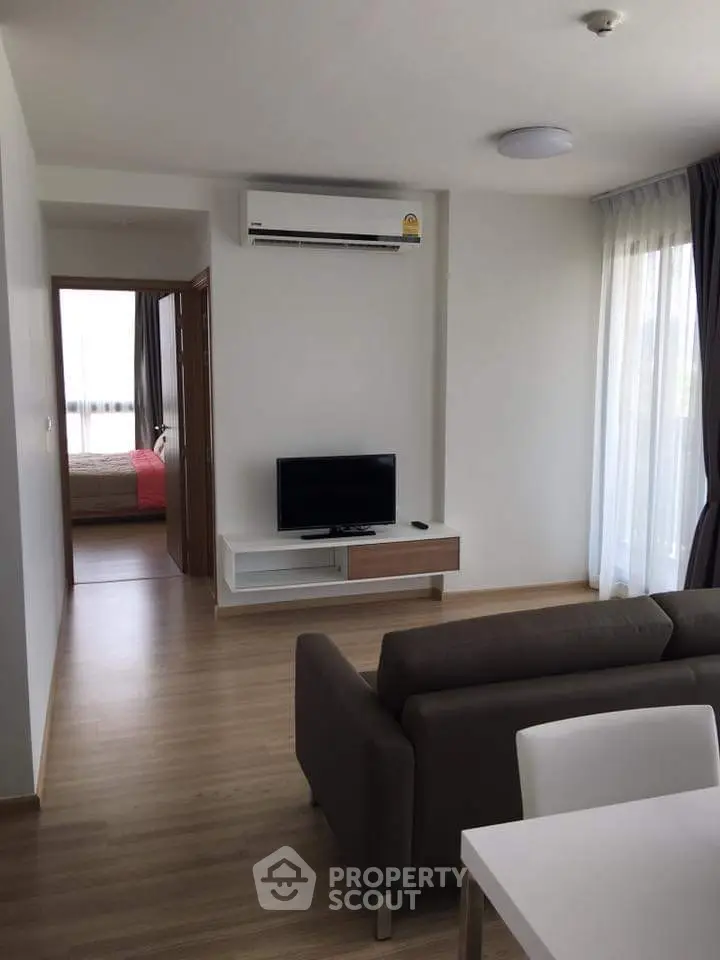Modern living room with sleek furniture and natural light in a stylish apartment.