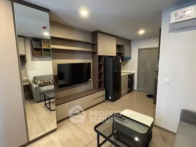 Modern living room with sleek furniture and integrated kitchen appliances.