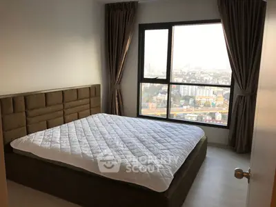 Modern bedroom with large window offering stunning city view