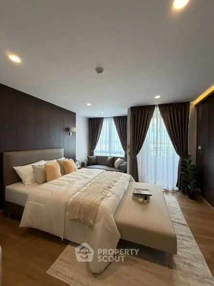 Luxurious bedroom with elegant decor and large windows for natural light