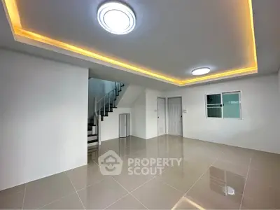 Modern minimalist interior with sleek staircase and ambient lighting, perfect for contemporary living.