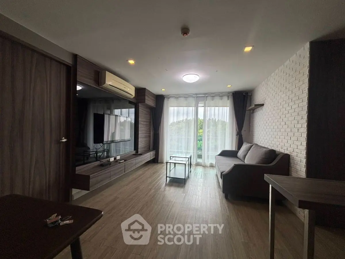 Spacious modern living room with large windows and stylish decor.