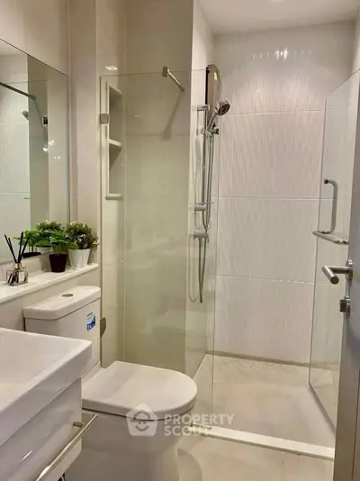 Modern bathroom with glass shower and sleek fixtures