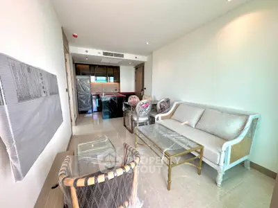 Modern living room with elegant furniture and open kitchen layout in a new apartment.