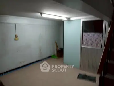 Spacious storage area with tiled floor and fluorescent lighting, ideal for organizing household items.