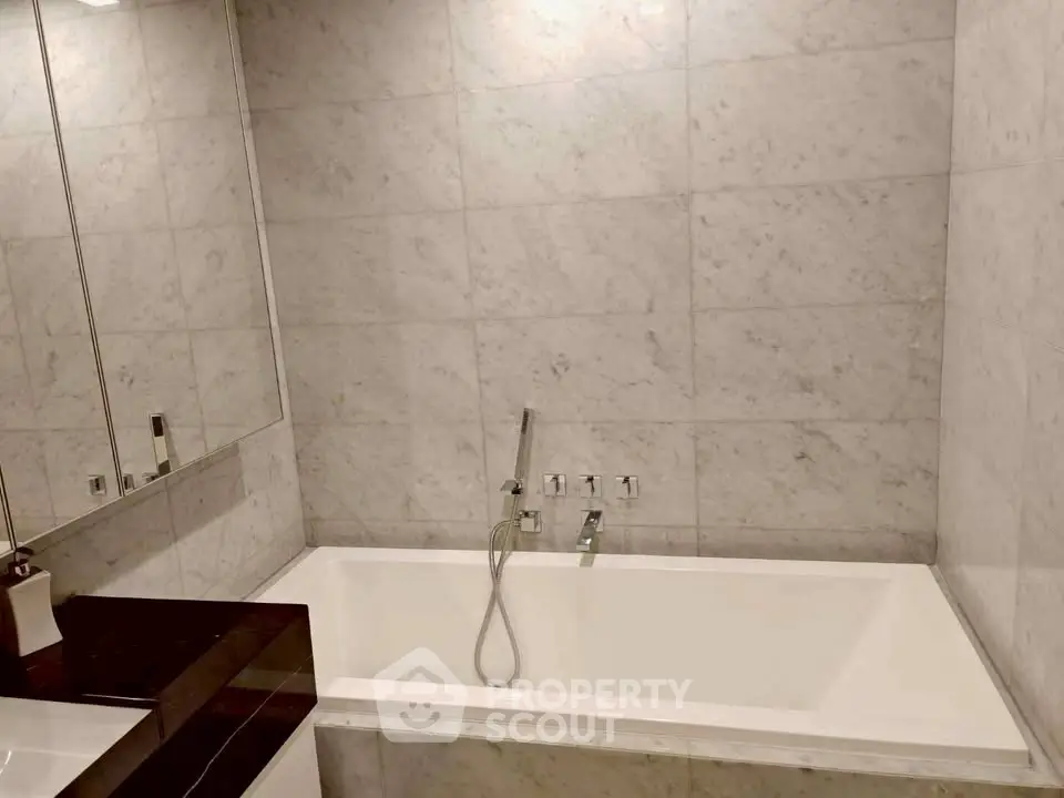 Luxurious bathroom with elegant marble tiles and modern bathtub