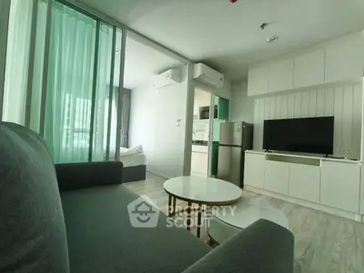 Modern living room with sleek furniture and open kitchen layout in a stylish apartment.