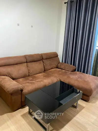 Cozy living room with brown sectional sofa and modern black coffee table