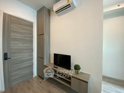 Modern living room with sleek wooden furniture and mounted air conditioning unit.