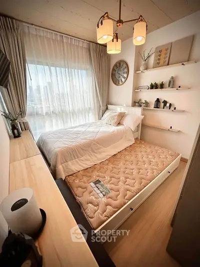 Cozy bedroom with modern decor and city view, featuring a pull-out bed and stylish lighting.