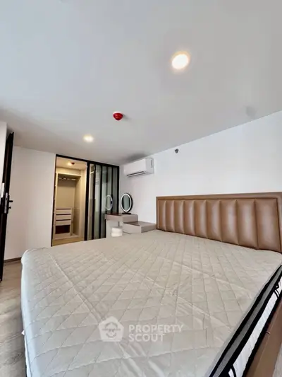 Modern bedroom with stylish decor and ample natural light