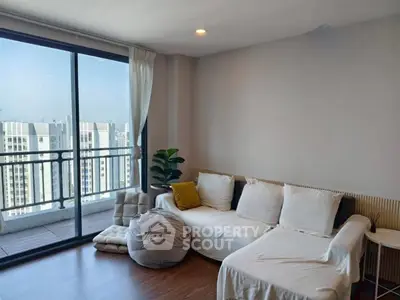 Spacious living room with large windows and balcony view in modern apartment