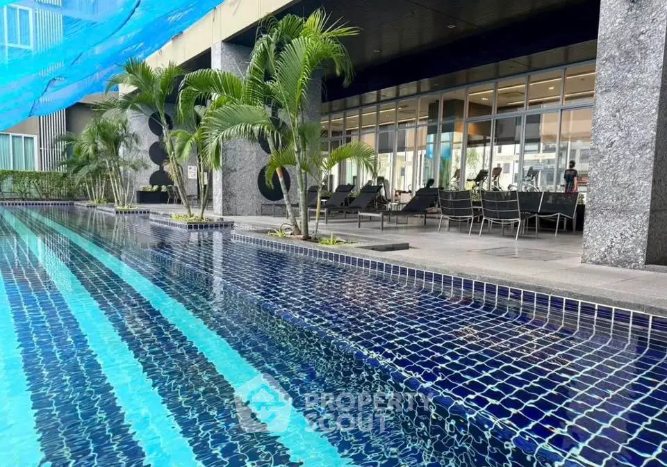 Luxurious condominium poolside with modern design and lush greenery
