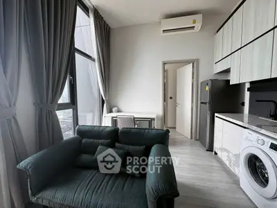 Modern apartment interior with stylish living room and kitchen, featuring large windows and sleek appliances.