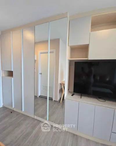 Modern living room with sleek built-in storage and large TV unit