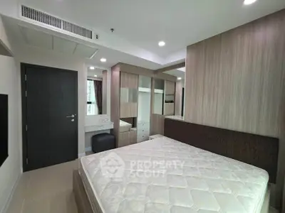 Modern bedroom with built-in wardrobe and cozy lighting in a stylish apartment.