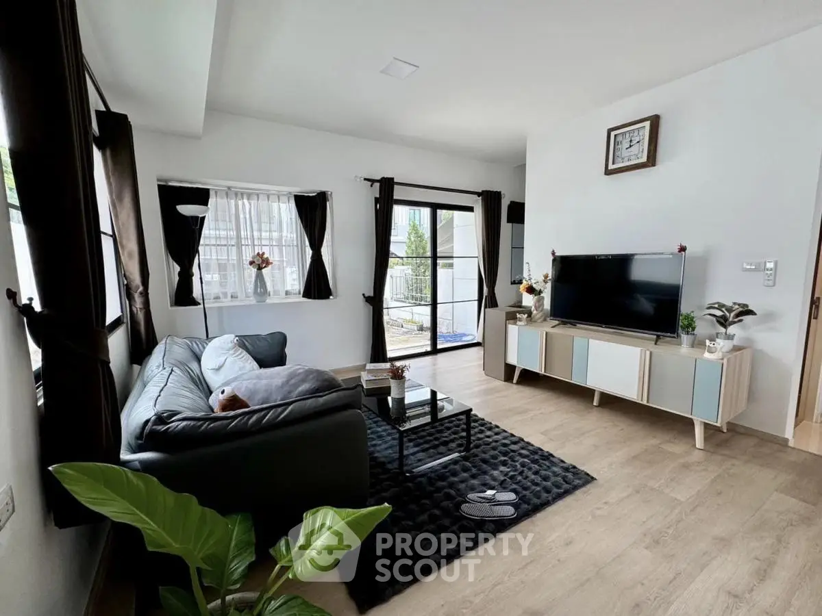 Modern living room with sleek furniture and natural light, perfect for relaxation and entertainment.