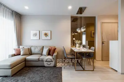 Modern living room with elegant decor and dining area, featuring a comfortable sofa and stylish lighting.