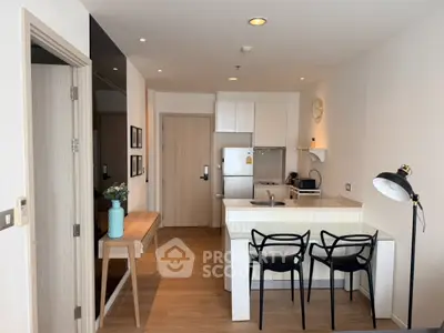 Modern open-plan kitchen and dining area with stylish decor and natural light.