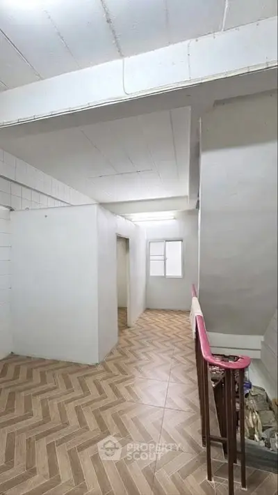 Spacious hallway with modern flooring and natural light, ideal for creative interior design.