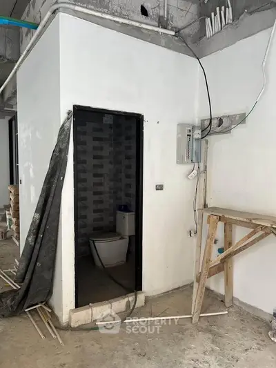 Under-construction bathroom with exposed wiring and unfinished walls, showcasing potential for customization.